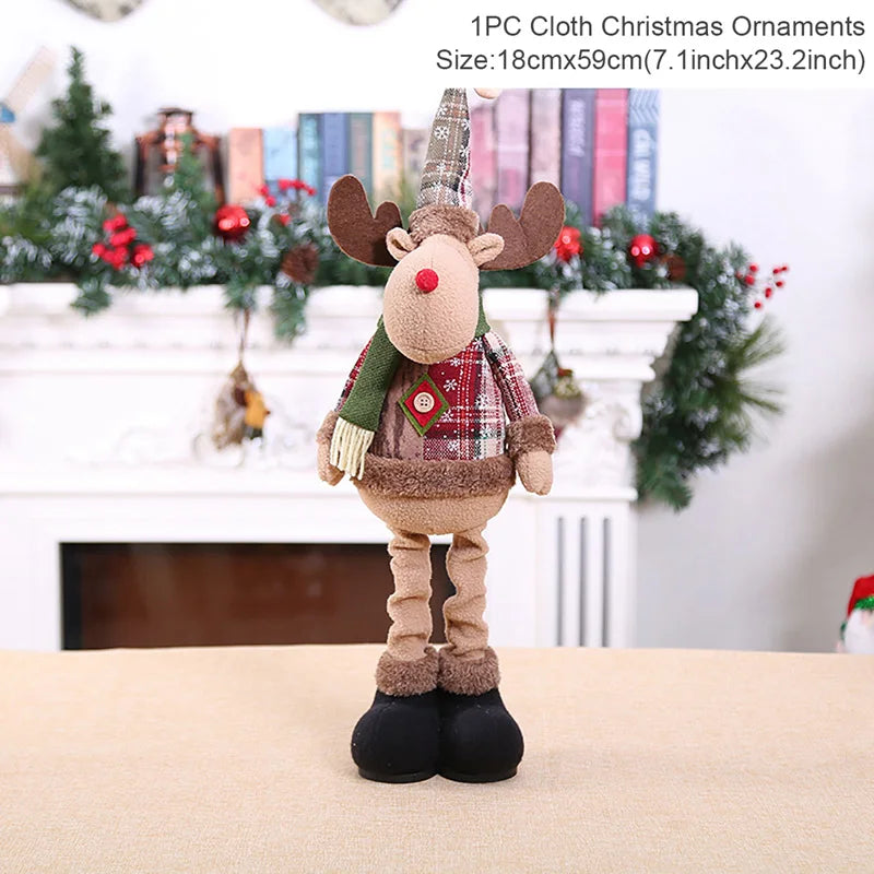 Plush reindeer Christmas ornament with a scarf standing in front of a decorated fireplace.