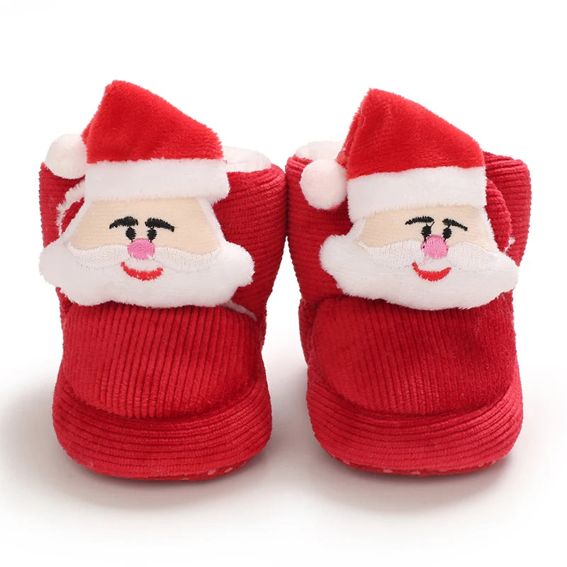 Red baby booties with Santa Claus face design on a white background
