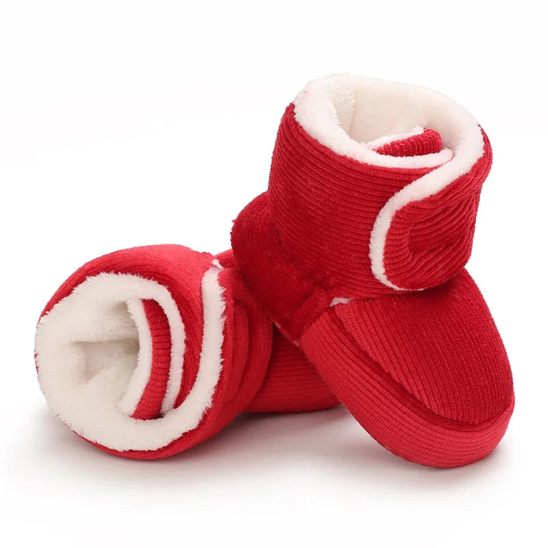 Red baby boots with white interior on a white background