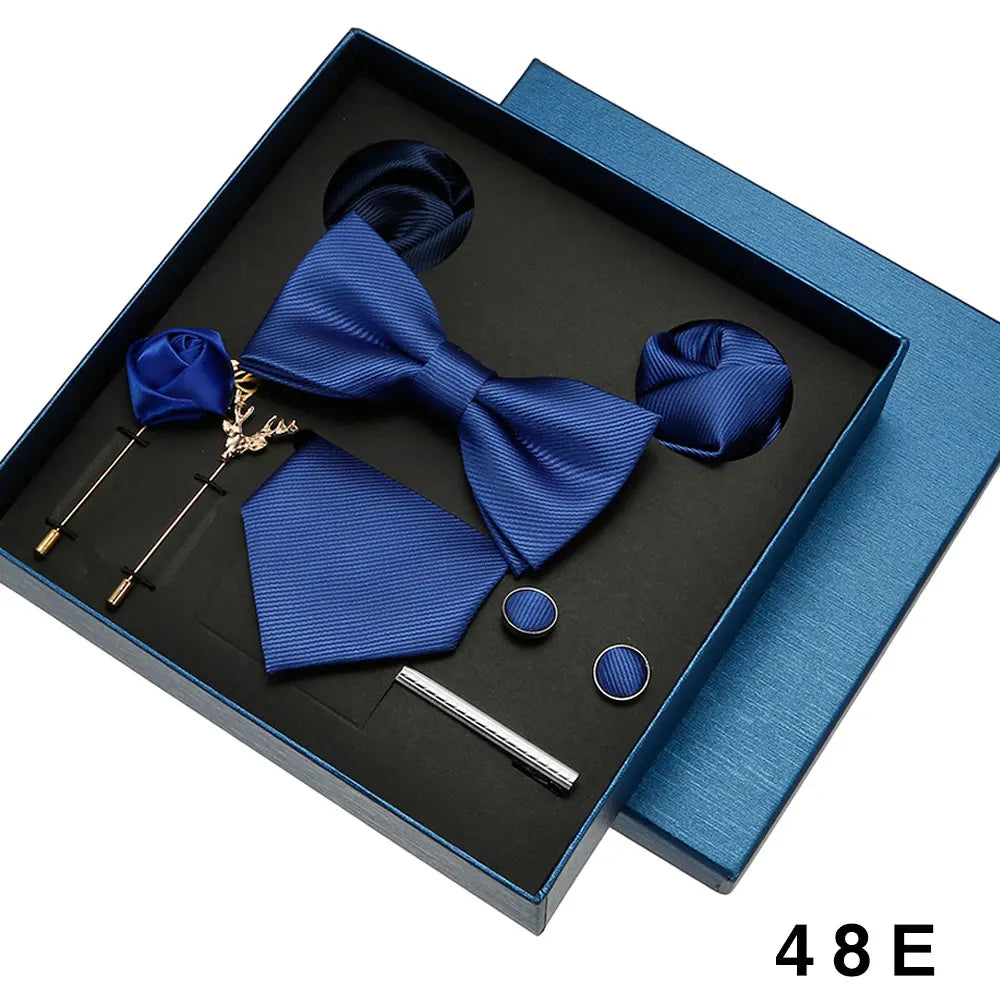 Blue bow tie set with accessories in a box.