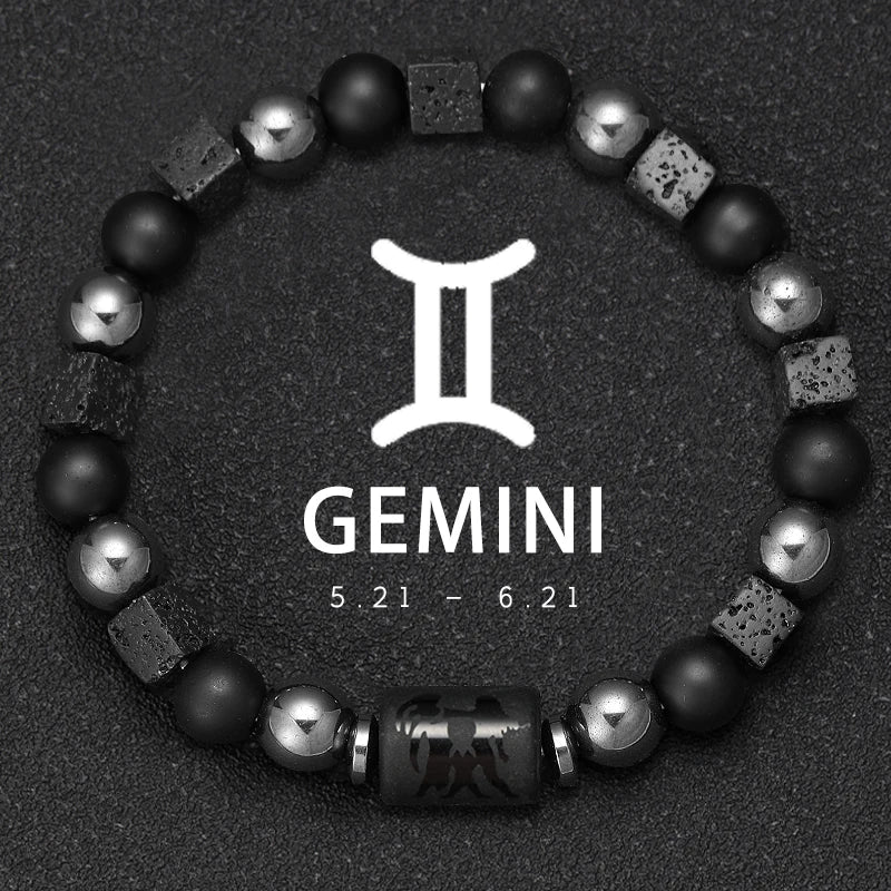 Bracelet with black and silver beads on a dark background with Gemini zodiac sign