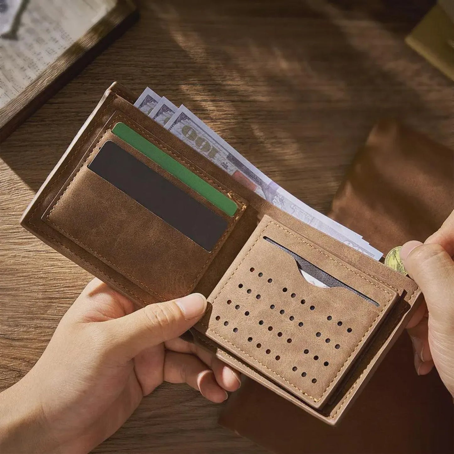 Brown leather wallet with cards and money on a wooden surface