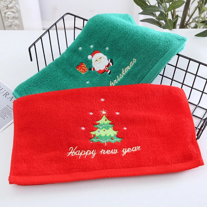 Red and green towels with Christmas themed designs on a white surface.