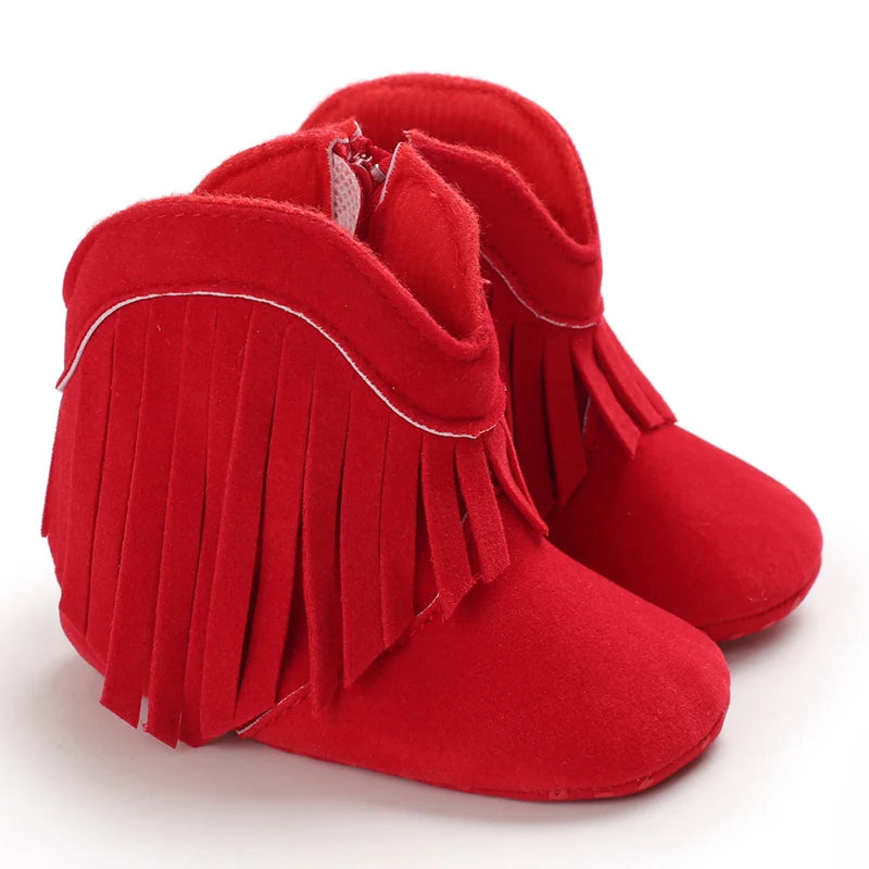 Red fringed baby boots on a white background