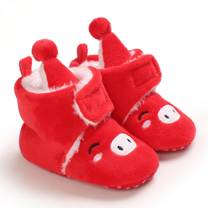 Red baby booties with Santa hats on a white background