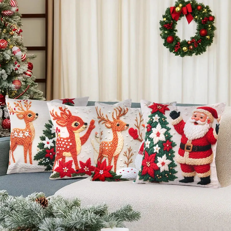 Decorative Christmas pillows with reindeer, Santa Claus, and Christmas tree designs on a couch.