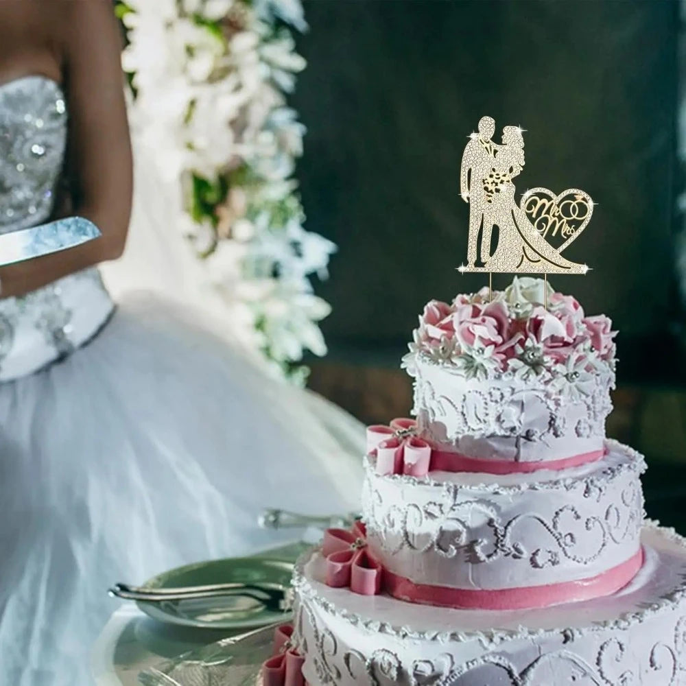Decorative wedding cake with a couple topper and floral decorations, blurred background