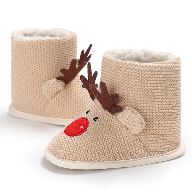 Beige knit slippers with reindeer face design on a white background