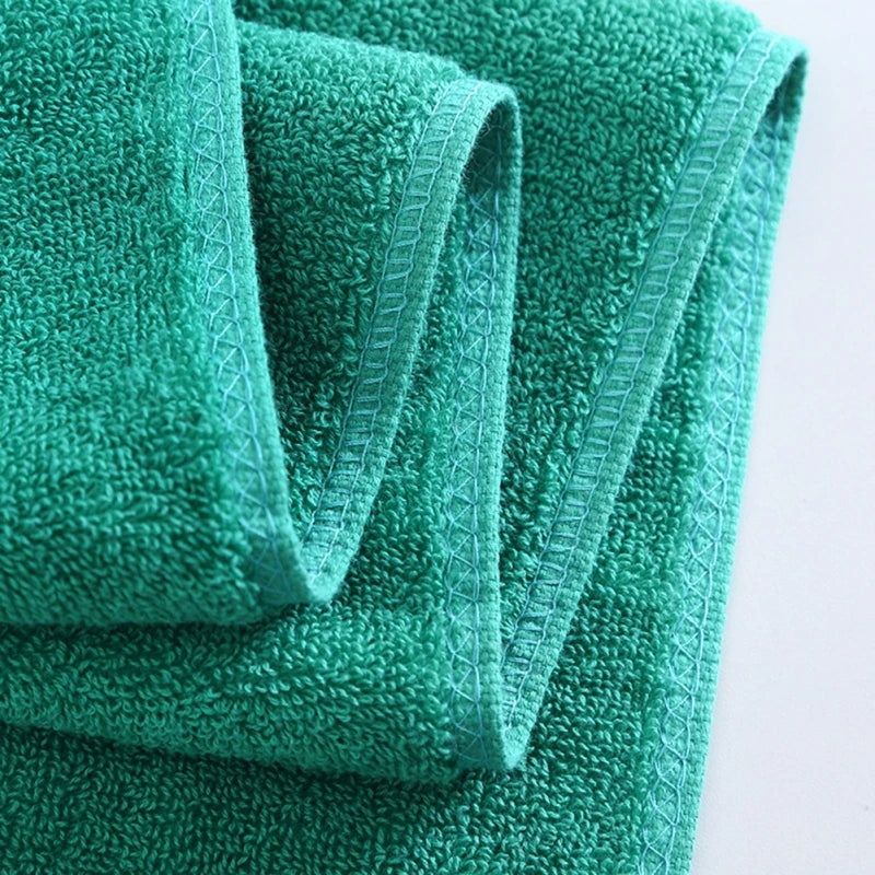 Green towel with textured surface on a light background