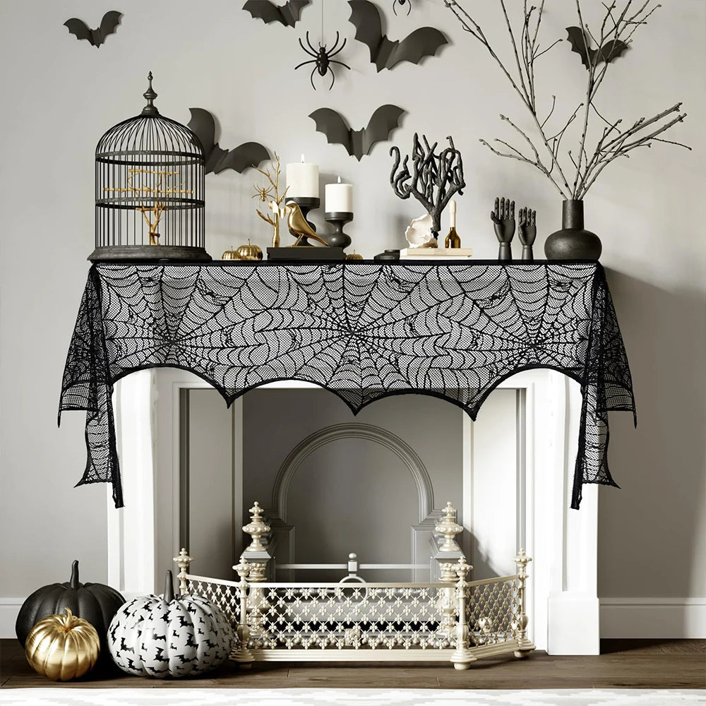 Halloween-themed decor with spider web tablecloth, pumpkins, and decorative items.