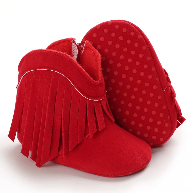 Red baby boots with fringe on a white background