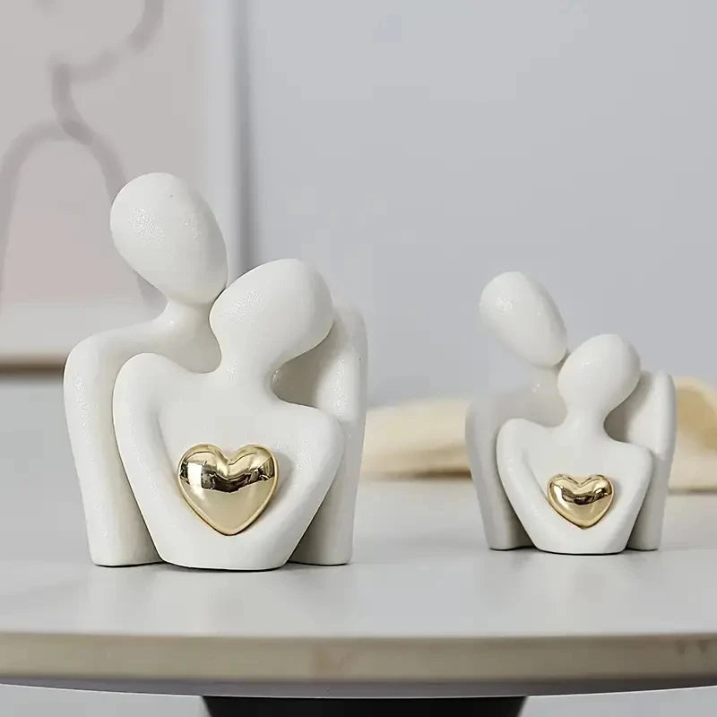 White figures with gold hearts on a light surface