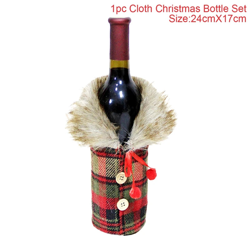 Red wine bottle wrapped in a plaid Christmas bottle cover with decorative buttons and pom-poms on a white background.