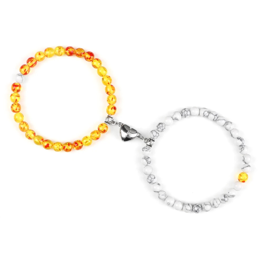 Gold and white bracelets set connected with heart