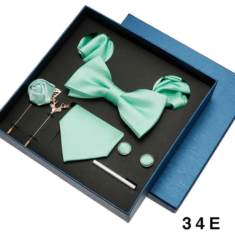 Mint green bow tie and pocket square set with accessories in a box.