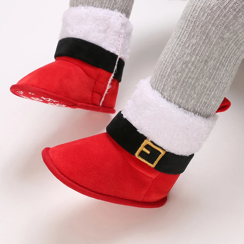 Red Santa-themed slippers with a black belt and white fur trim on a light background