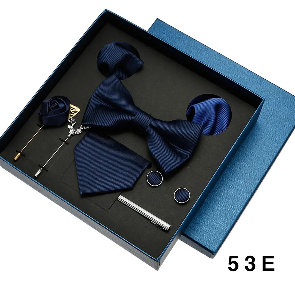 Navy blue bow tie set with accessories in a box.