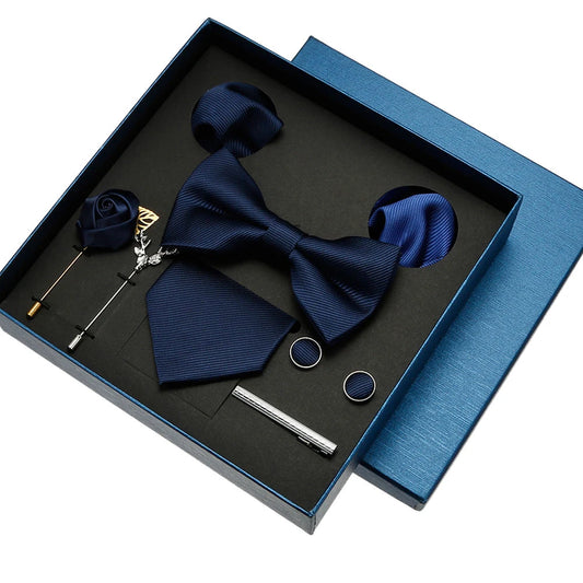 Navy blue bow tie set with accessories in a box