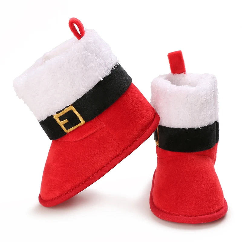 Red Santa Claus-themed baby booties with white fur and black belt on a white background