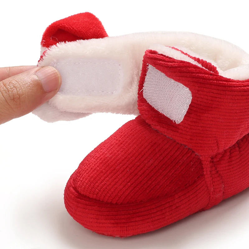 Red baby bootie with white fur lining with sticky closer