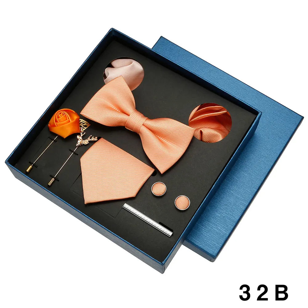 Peach bow tie and accessories set in a blue box with.