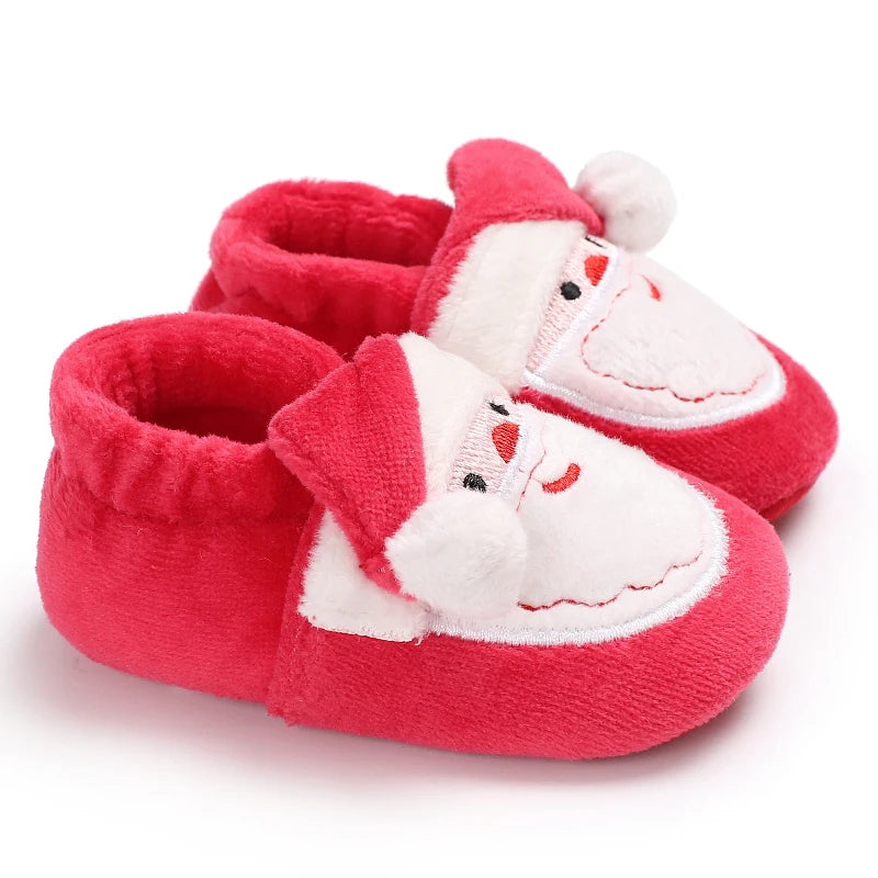 Red baby shoes with Santa Claus design on a white background