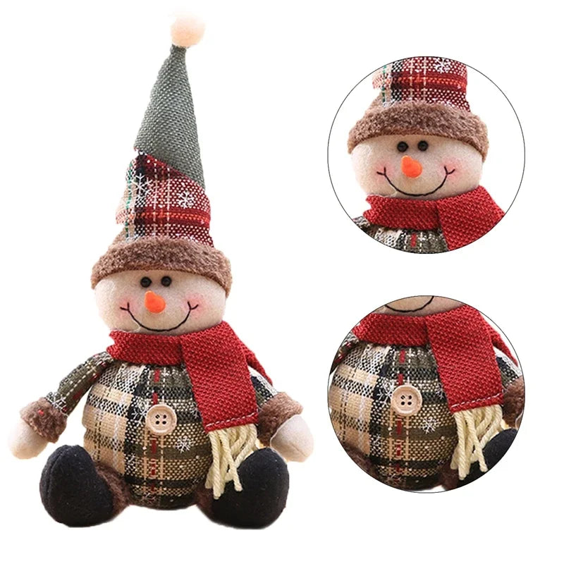 Plush snowman toy with plaid outfit, red scarf, and gray hat on a white background.