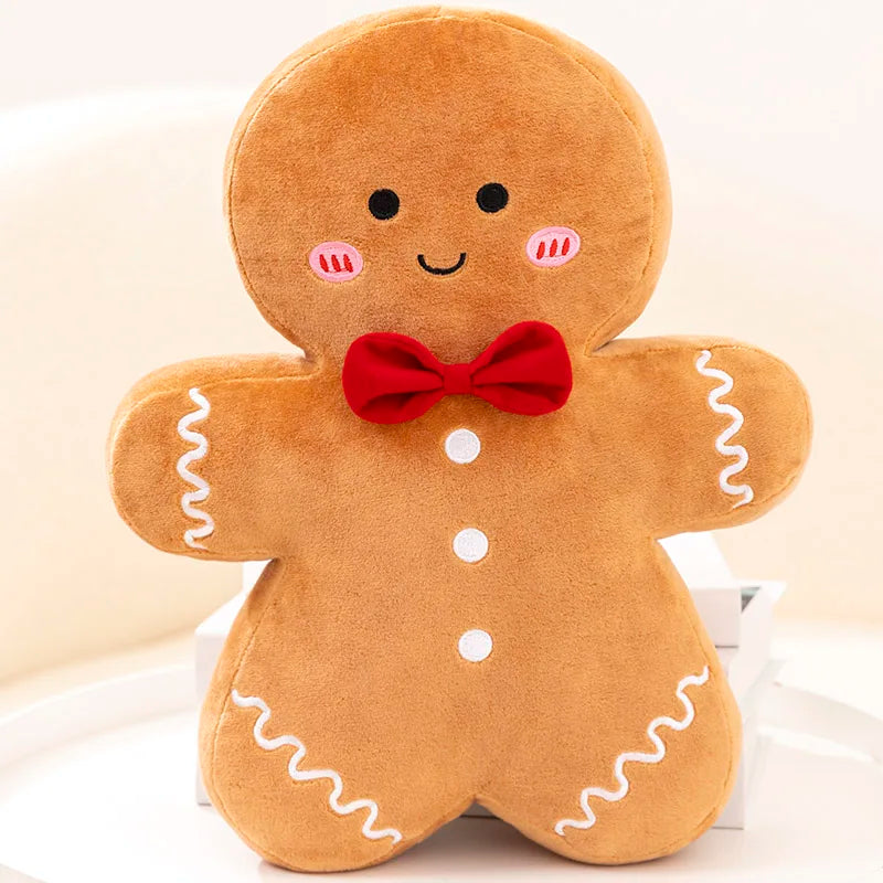 Plush toy gingerbread man with a red bow tie on a light background