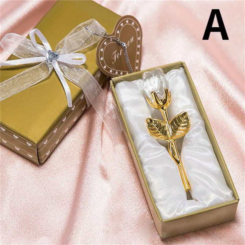 Gold rose in a box with a bow on a pink fabric background