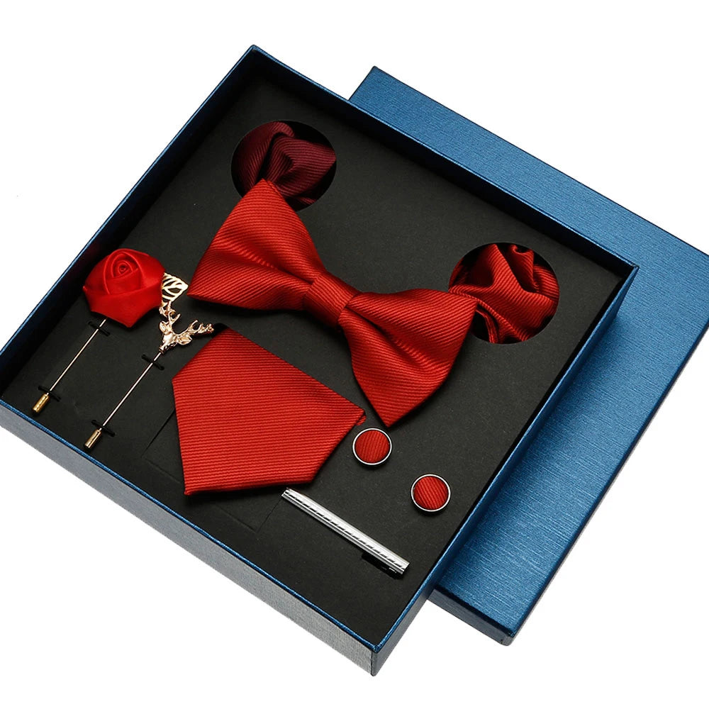 Red bow tie, pocket square, and accessories in a blue box