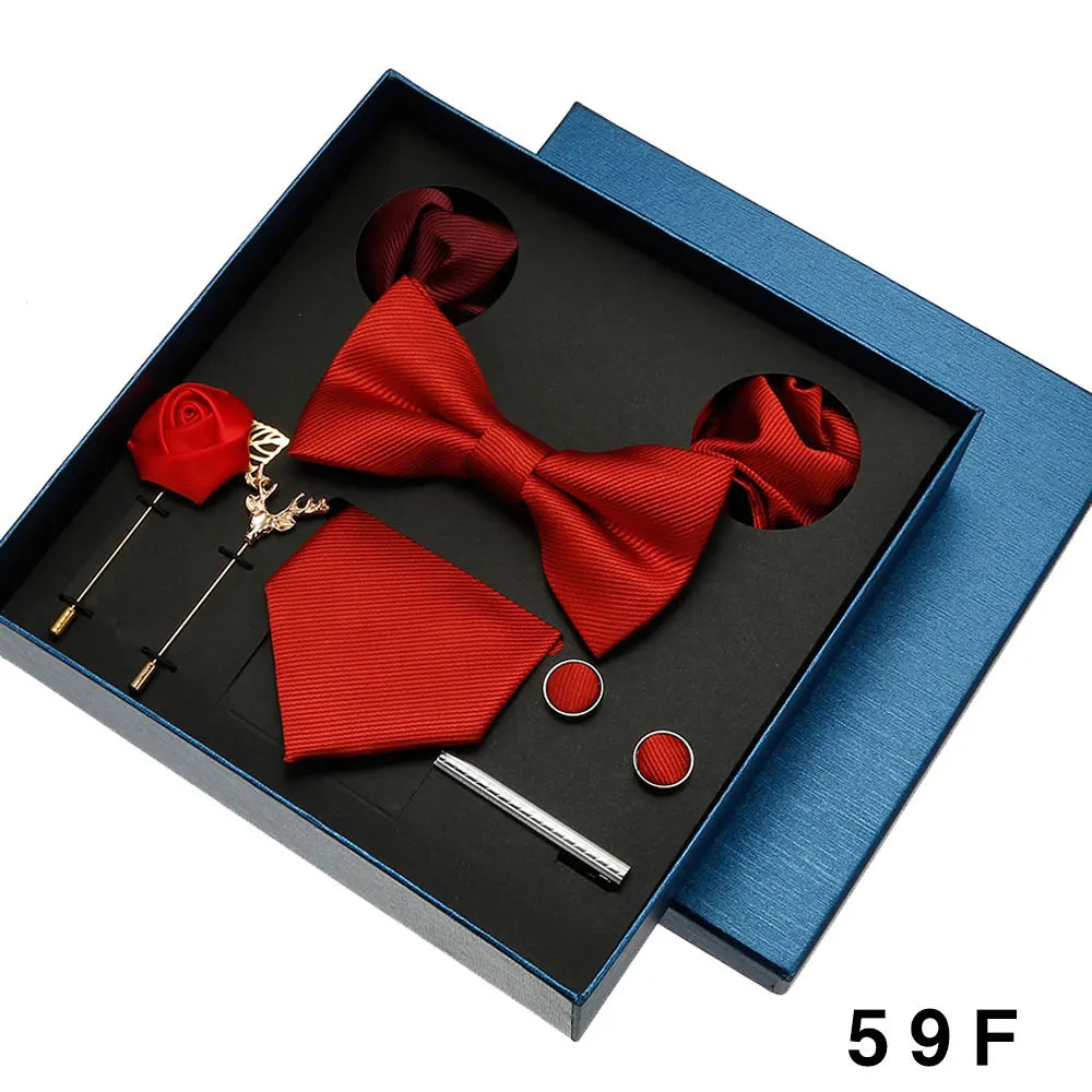 Red bow tie, pocket square, and accessories in a blue box