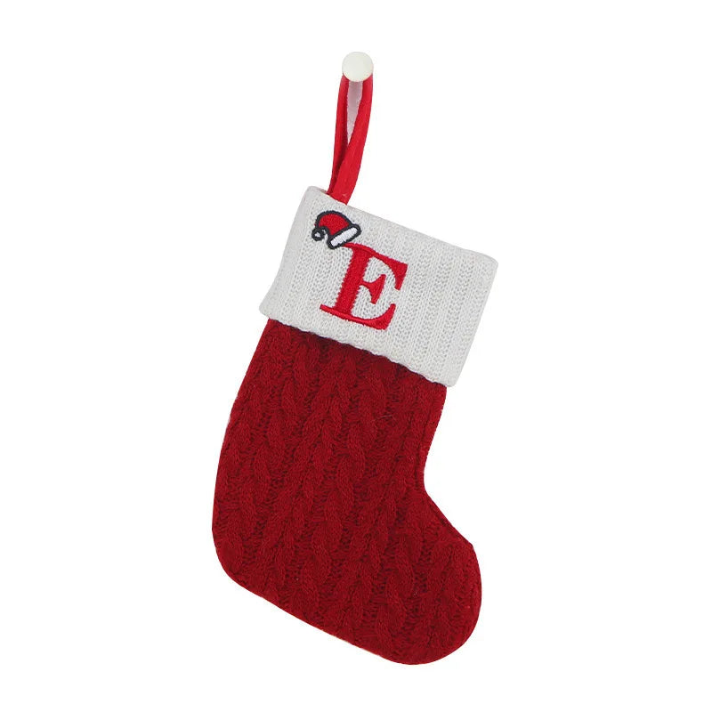 Red knitted Christmas stocking with a white cuff featuring the letter 'E' on a white background.