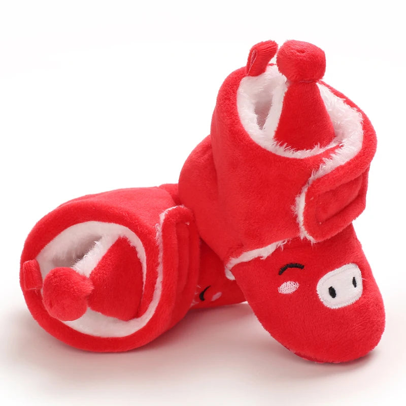 Red plush slippers with cartoon face design on a white background