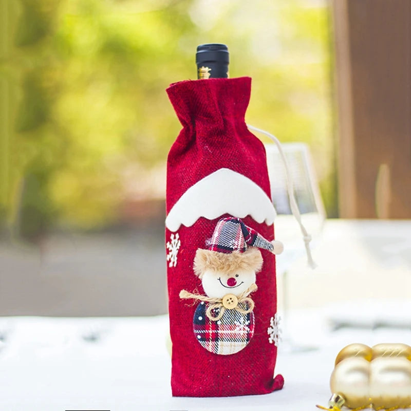 Red wine bottle cover with a snowman design on a blurred outdoor background