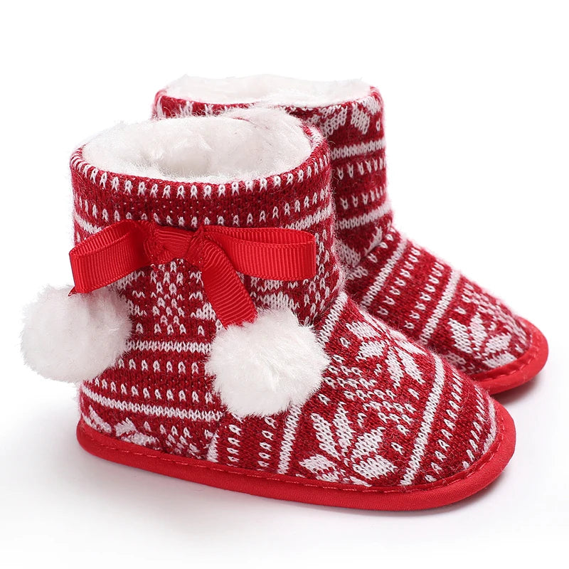 Red and white patterned slippers with bows and pom-poms on a white background