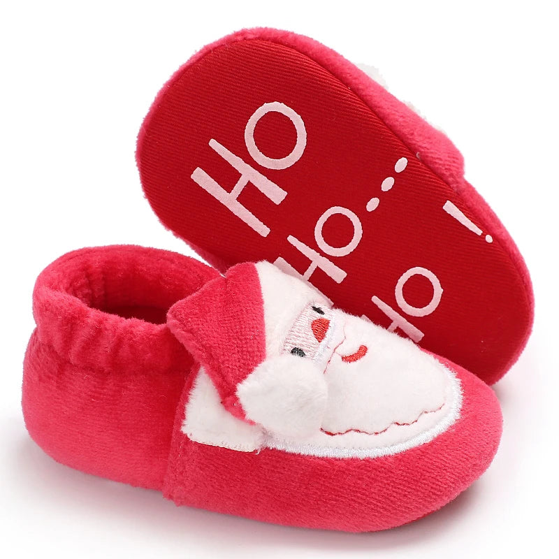 Red baby booties with Santa face and 'Ho Ho Ho' text on a white background