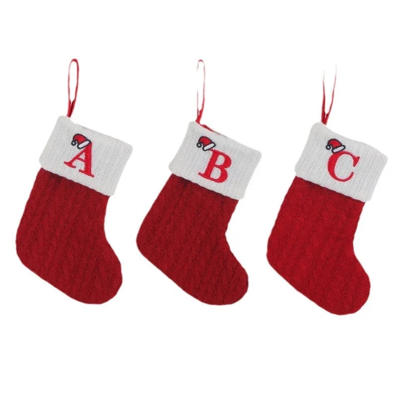 Three red Christmas stockings with white tops, each lettered 'A', 'B', and 'C'.