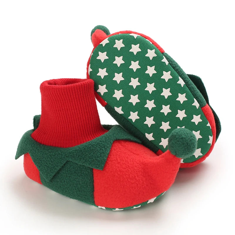 Red and green baby Elf booties with star pattern on a white background