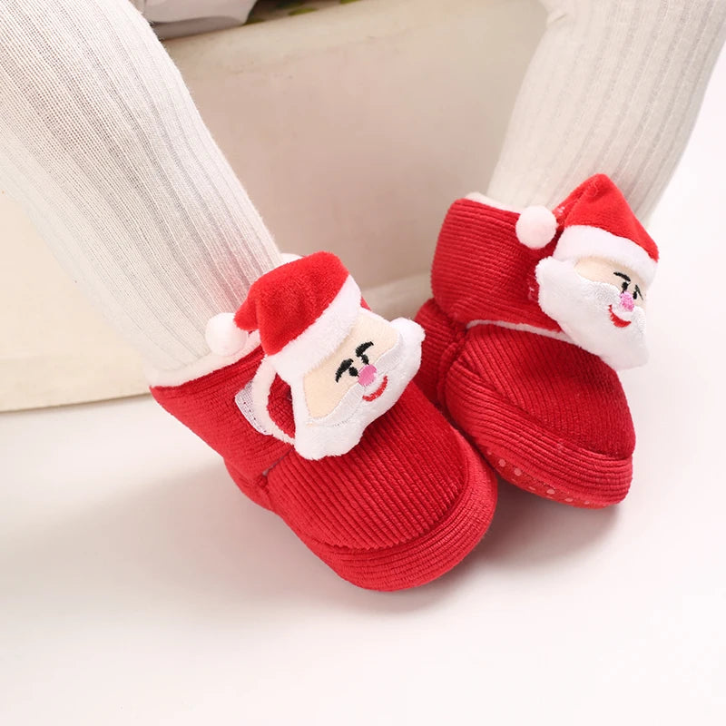 Red Santa Claus-themed baby shoes on a white background