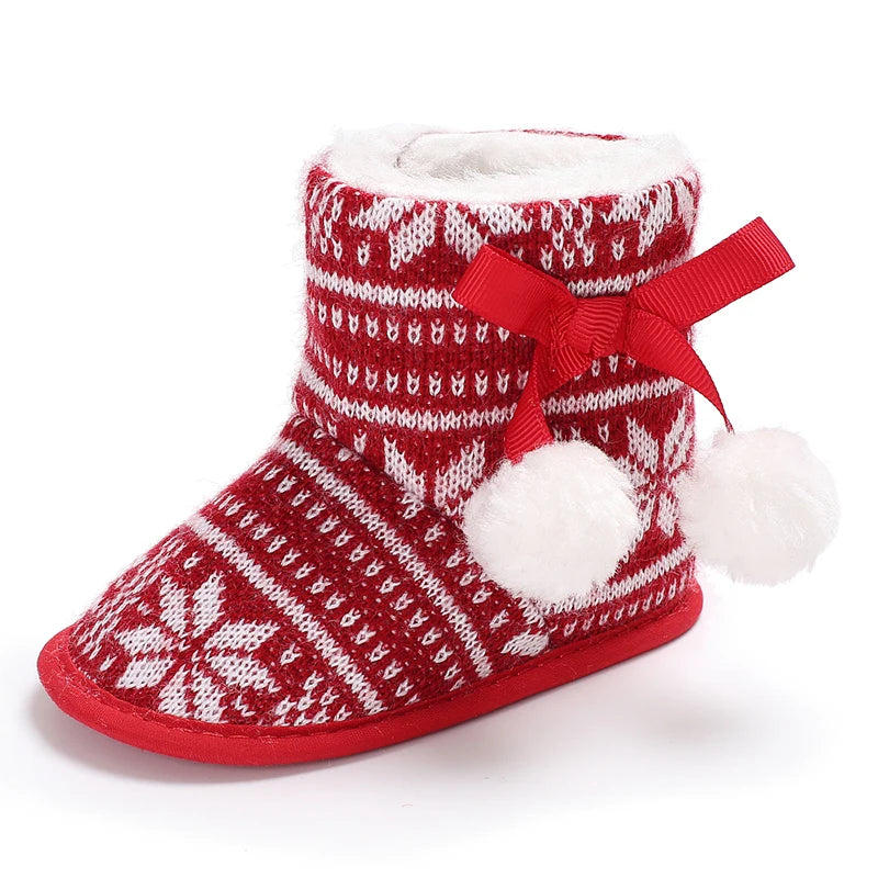 Red and white patterned slipper boot with a bow and pom-poms on a white background