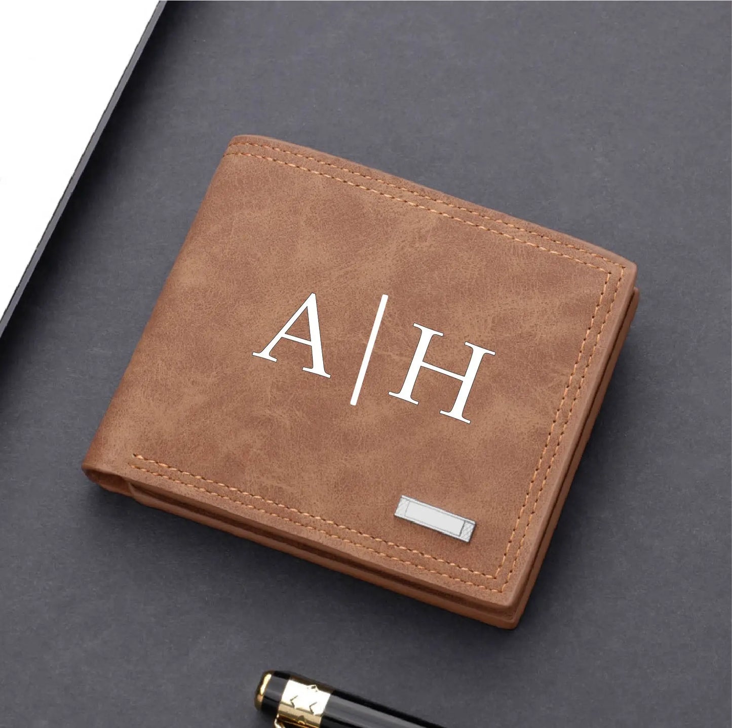 Brown leather wallet with initials 'A|H' on a dark surface