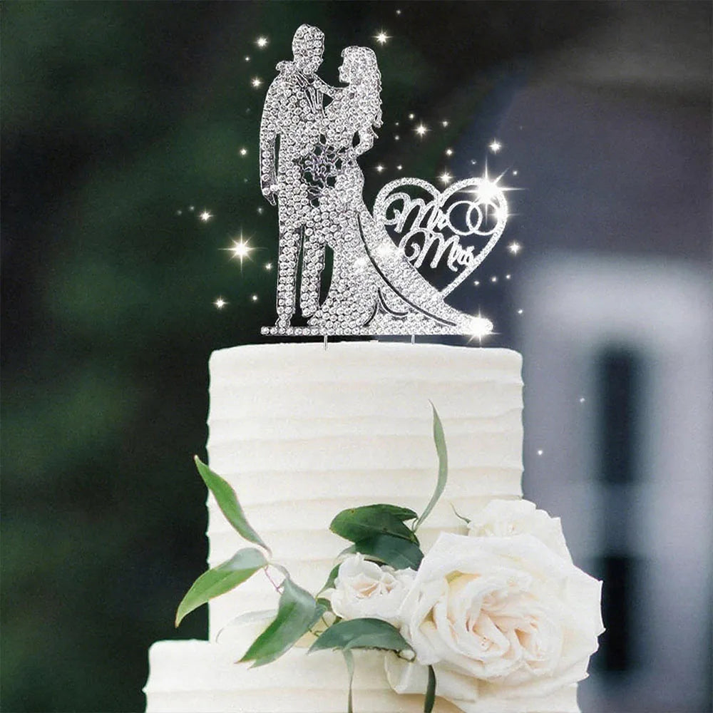 Wedding cake with a decorative topper featuring a couple and 'Mr & Mrs' on a white cake.