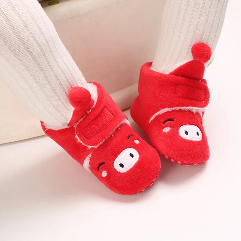 Red baby socks with cartoon face design on a white background