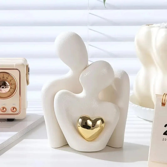 White heart-shaped figurine with a gold heart in the center on a light background.