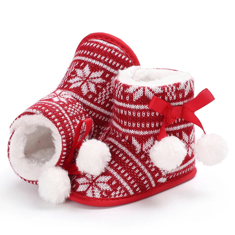 Red and white patterned slippers with white fur lining and red bows on a white background