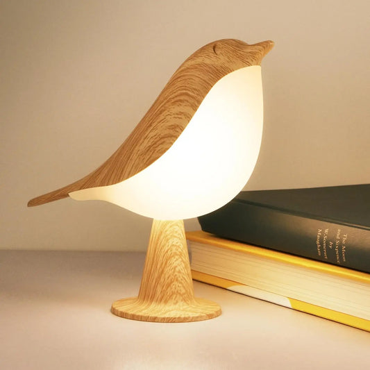 Wooden bird-shaped lamp on a surface with a book in the background