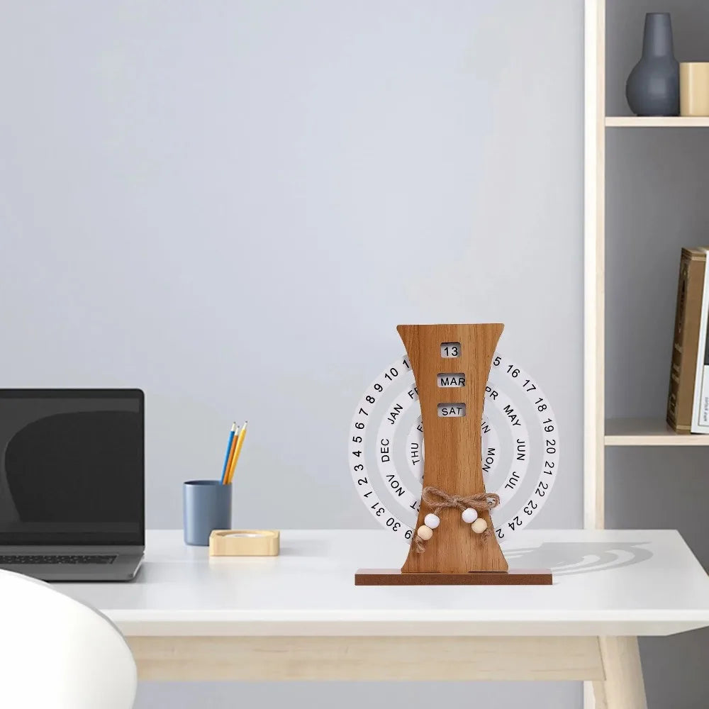 Wooden handmade calendar on a desk with a laptop and office supplies in the background