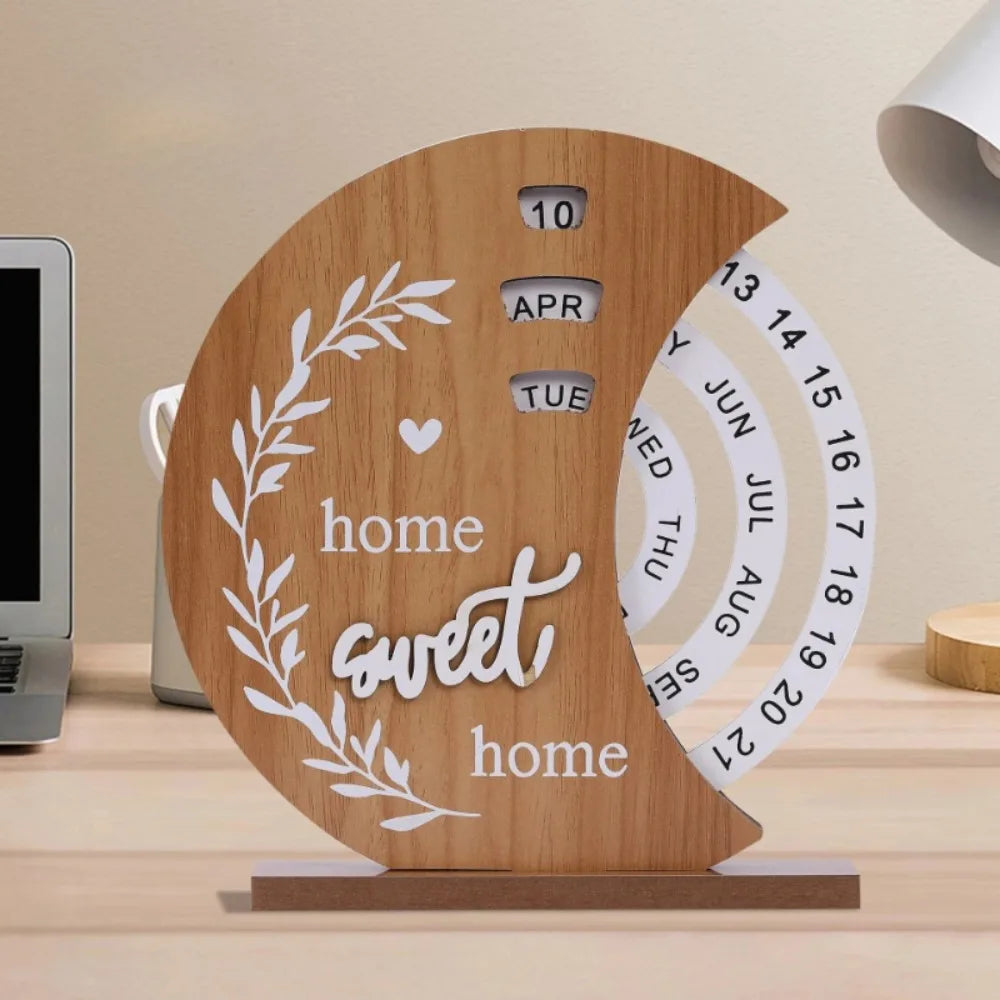 Wooden calendar with 'home sweet home' phrase on a desk.